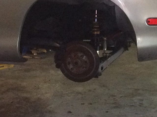 A car with its front suspension in the dark.