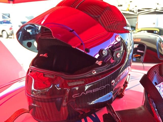 A red and blue helmet sitting on top of a table.