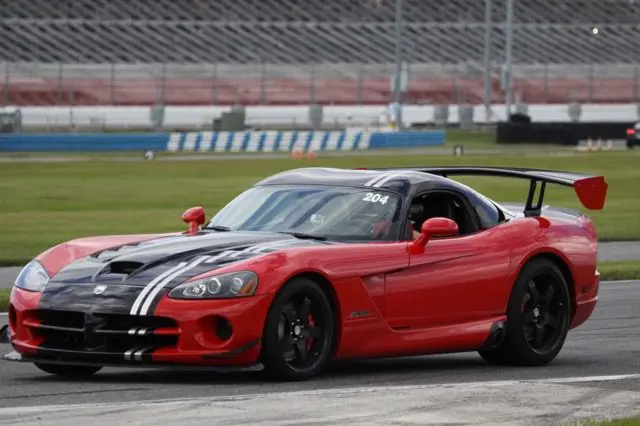 A red sports car is driving on the track.