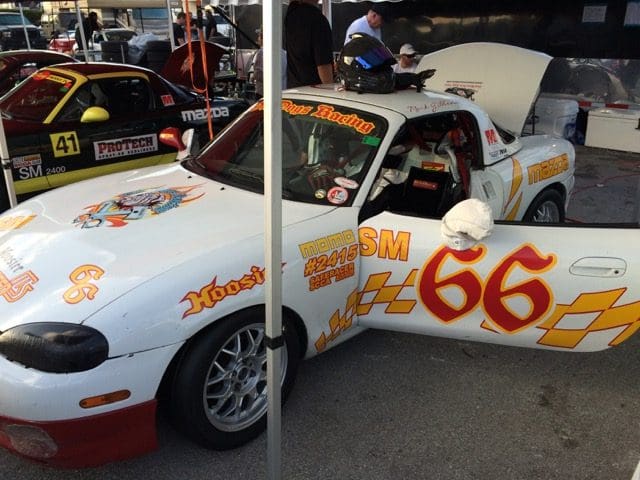A white race car with flames on the side.
