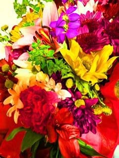 A bouquet of colorful flowers is sitting on a table.