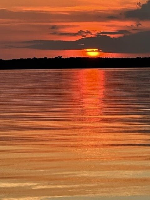 The sun is setting over a body of water.